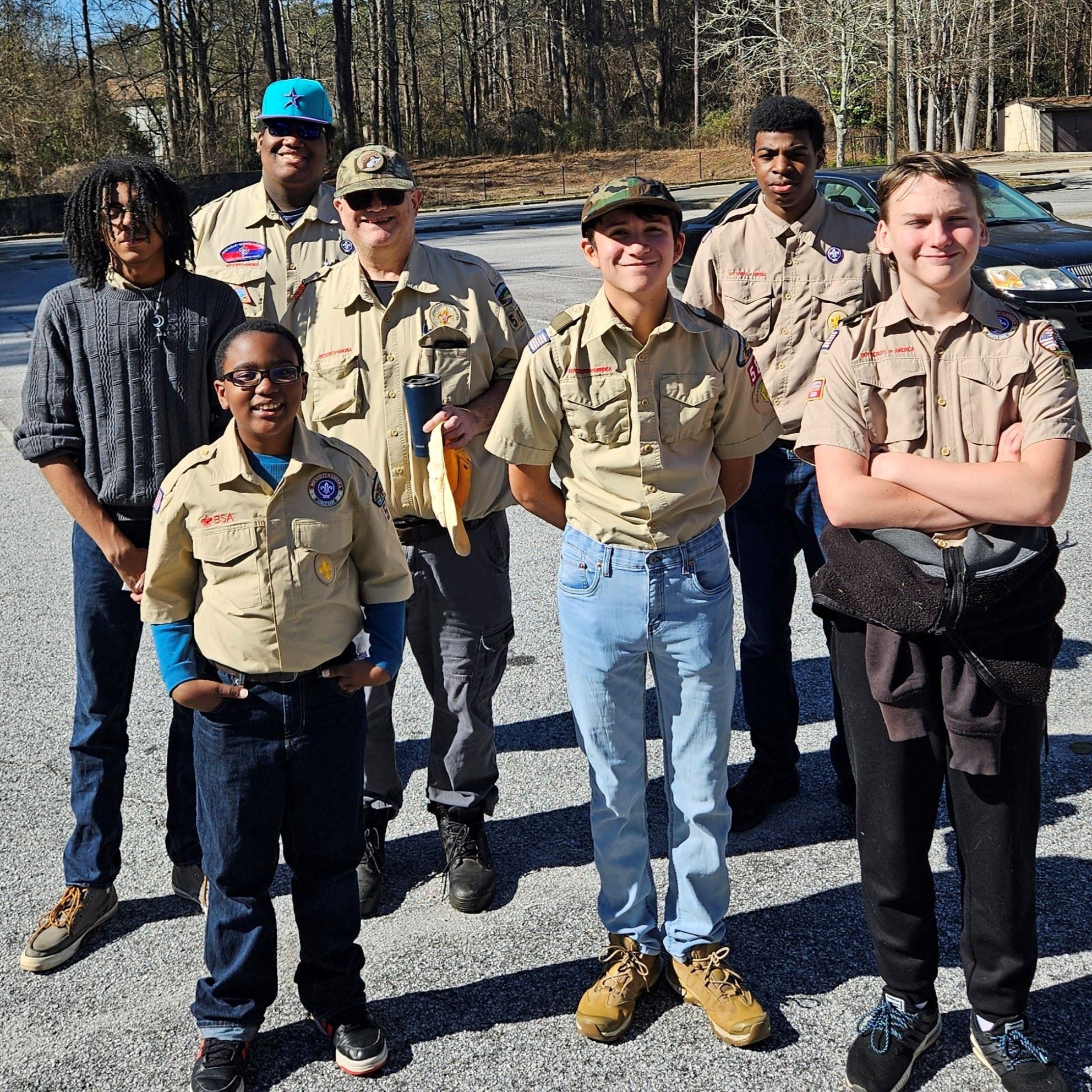 Group of boy scouts pose for picture in parking lot (Scouts Troop 582 of the Sweetwater District)