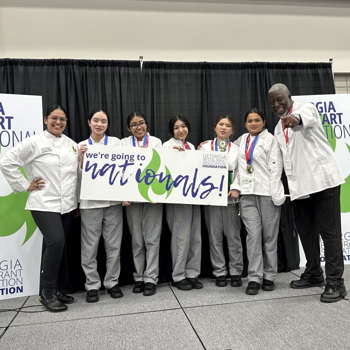 students and teacher pose with 