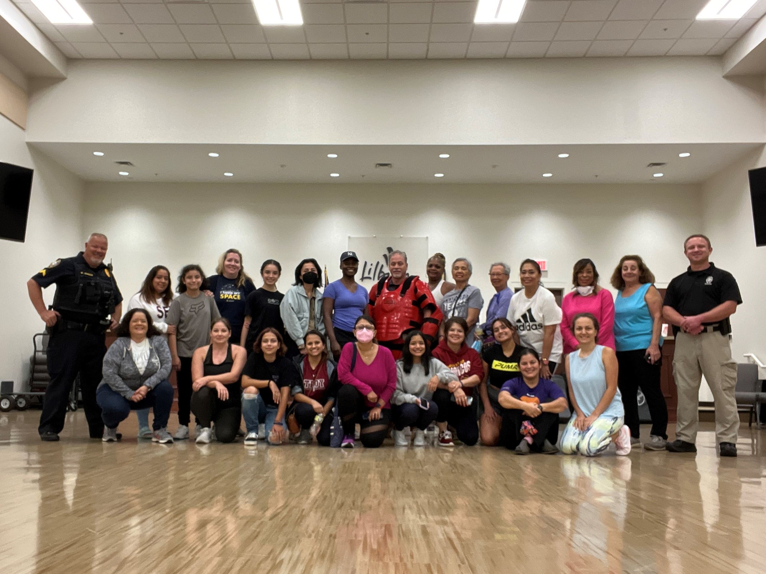 group picture of women from a safety defense class with their police instructors