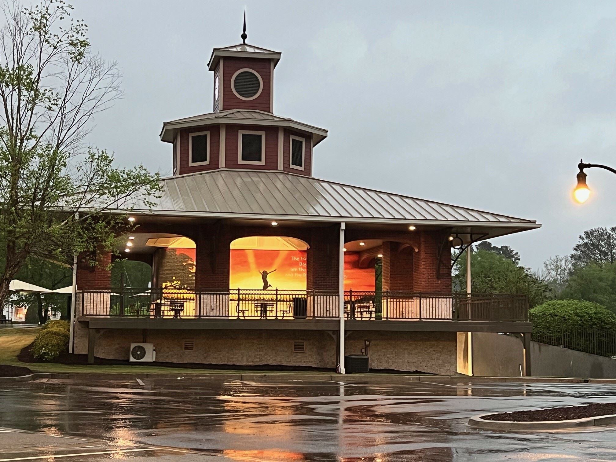 painted mural of a female silhouette jumping in front of a sunset with a quote