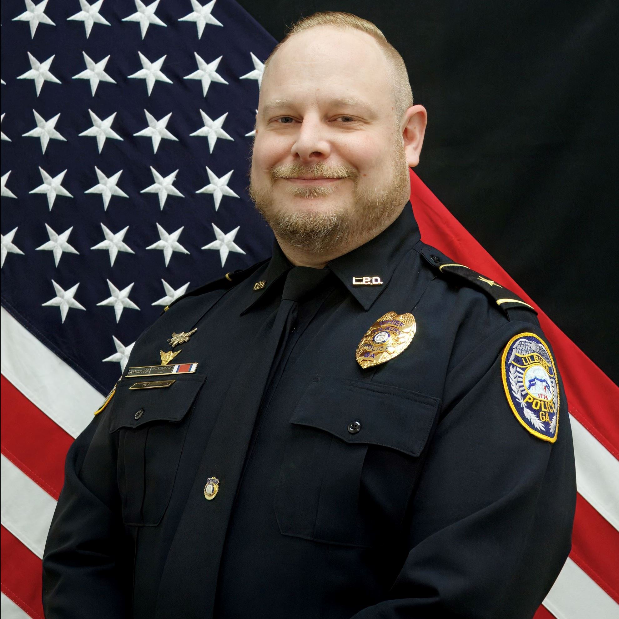 Headshot of Chris Dusik male officer in uniform with blonde hair and beard