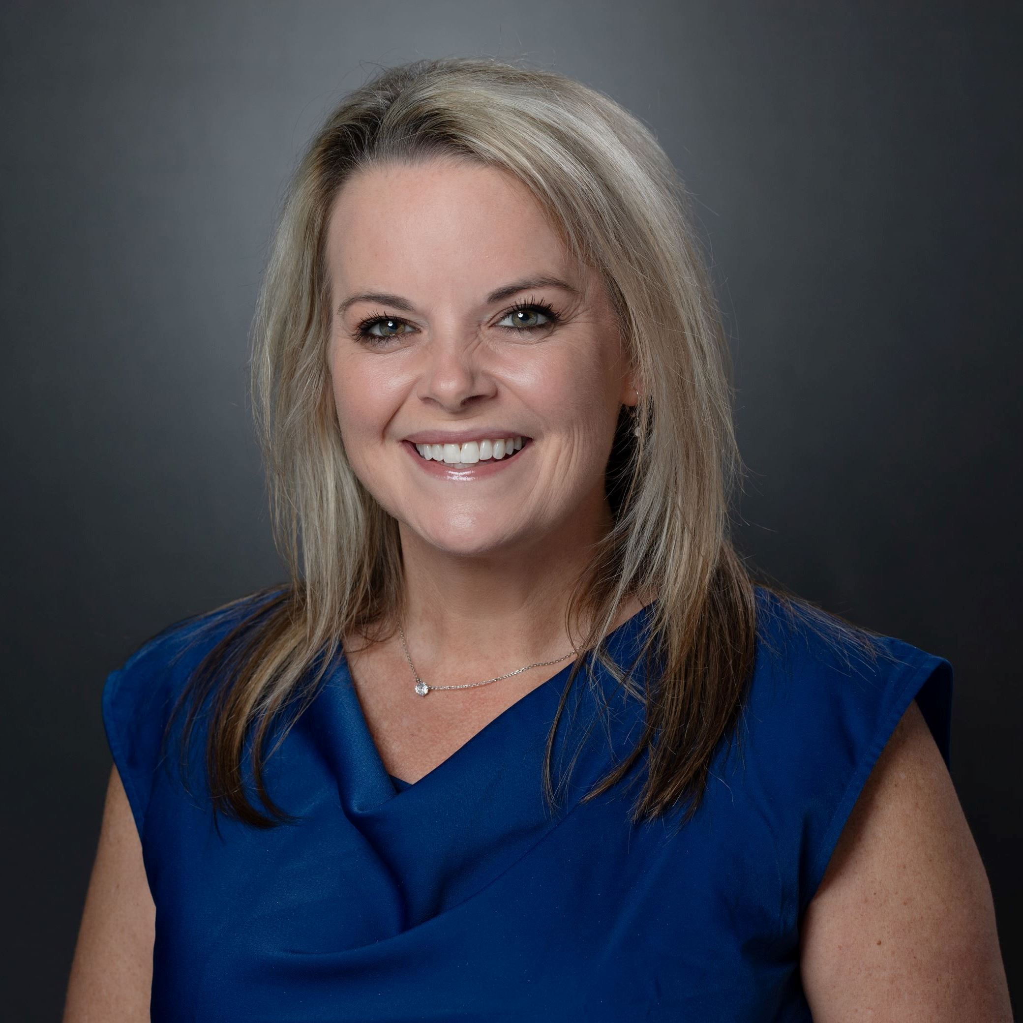 Headshot of Leighanne Lloyd female with medium length blonde hair wearing blue blouse