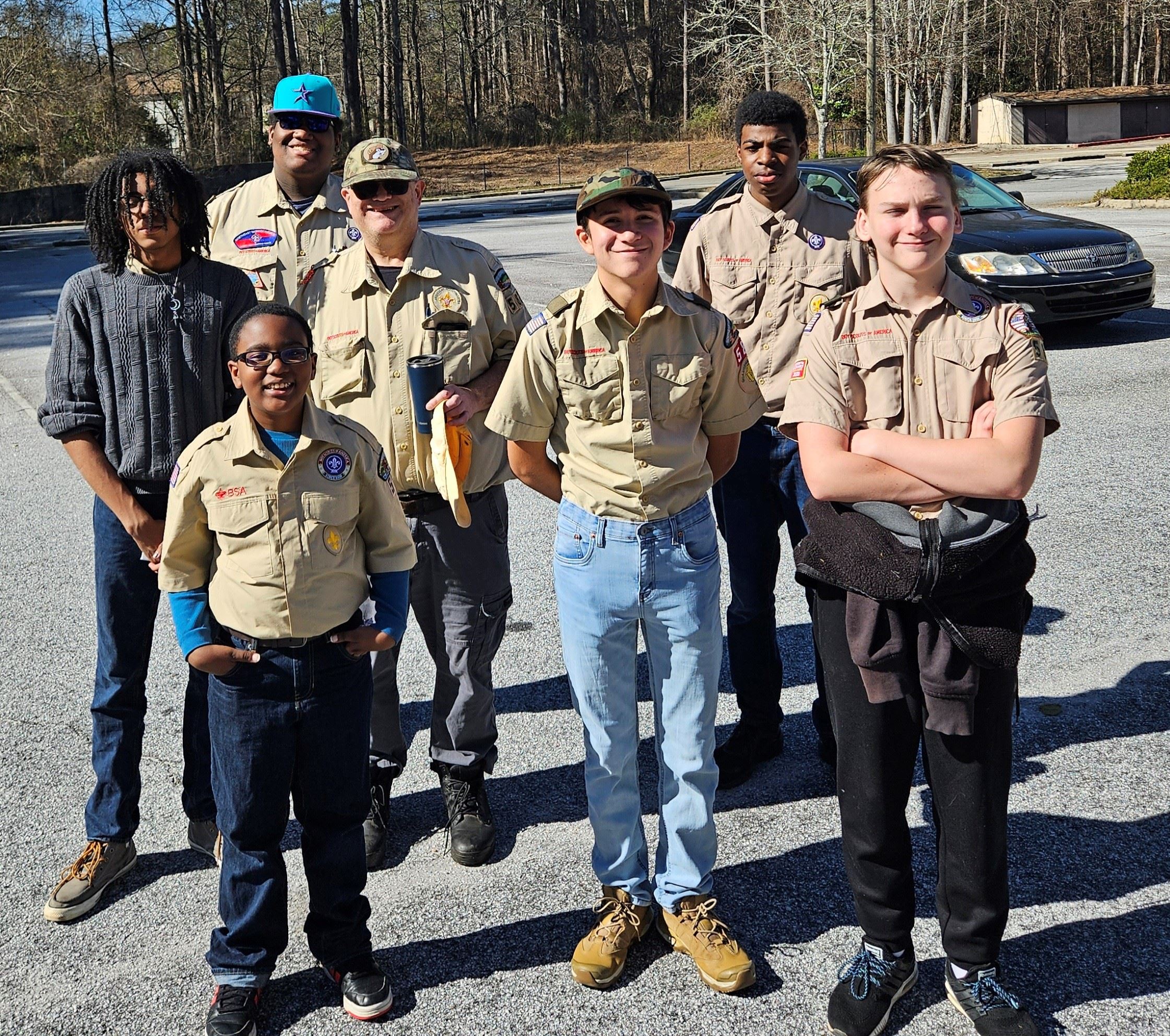 Group of boy scouts pose for picture in parking lot (Scouts Troop 582 of the Sweetwater District)