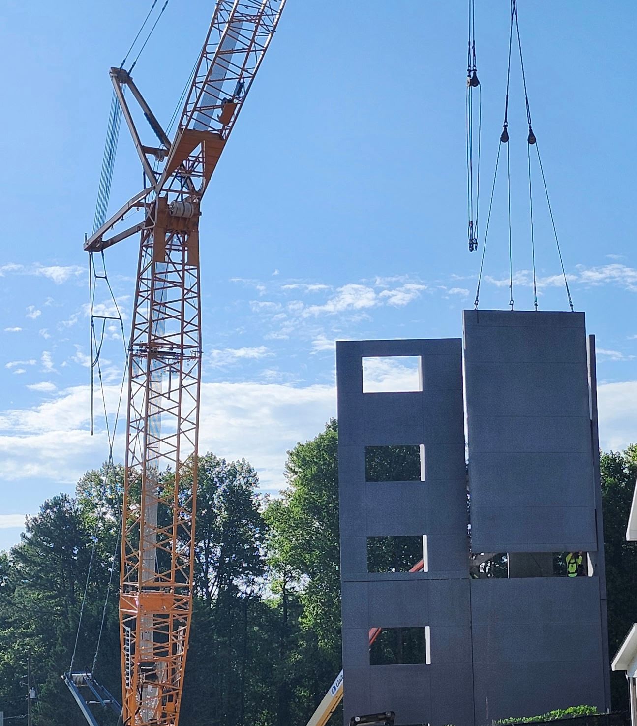 crane installing tall concrete tower structure
